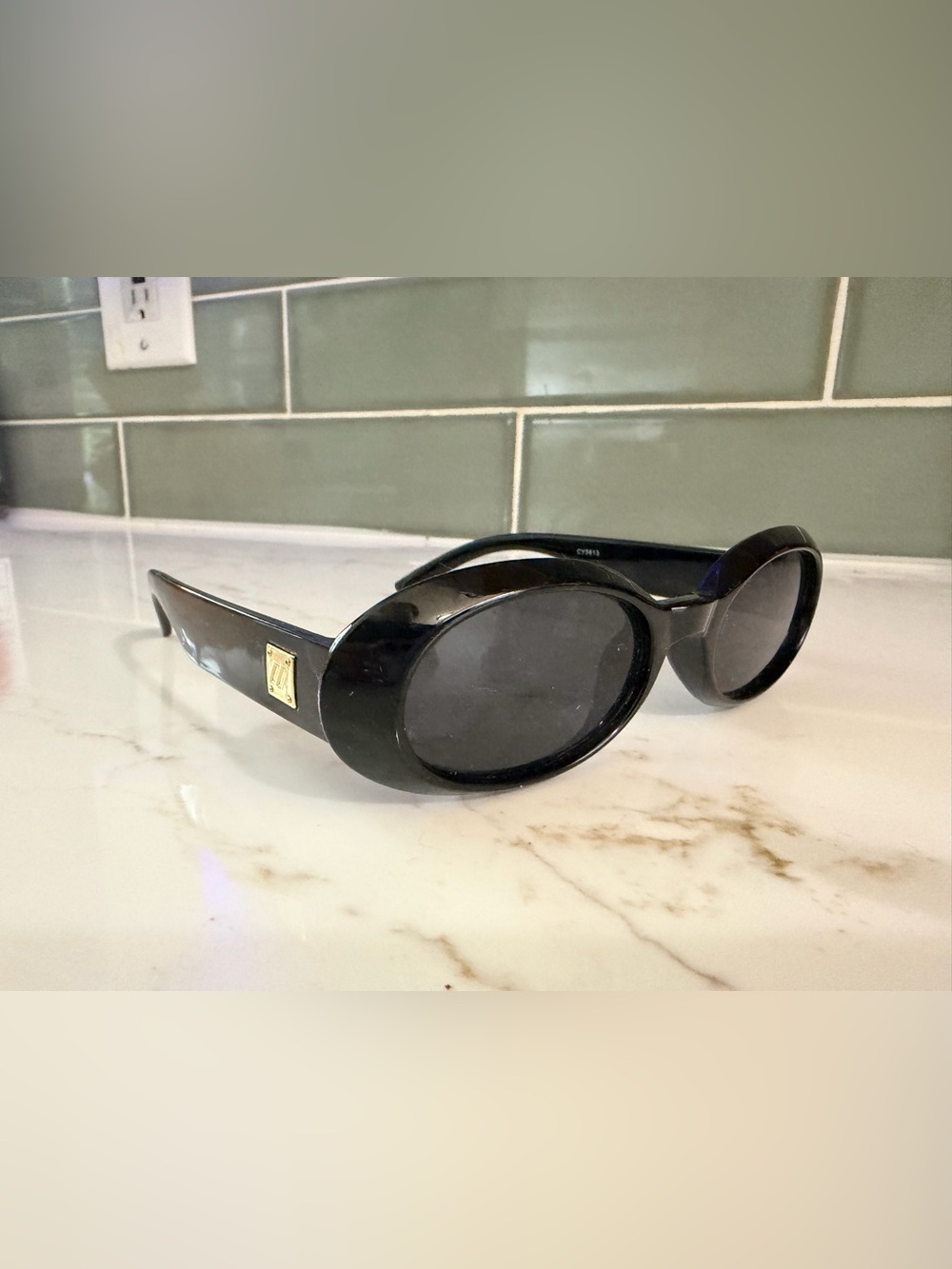 Black Oval Sunglasses with Gold Accent